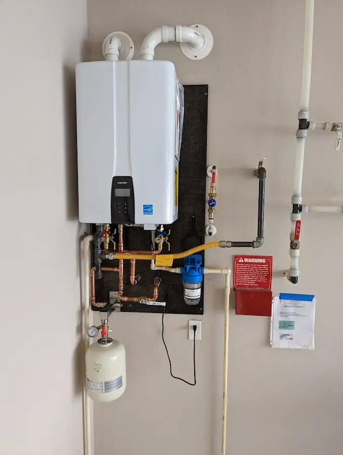 Professional plumber installing copper piping in a Fishers home